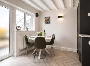 a dining room with a table and chairs at Beautiful Abode in The Bath Cotswolds in Frome +5 photos