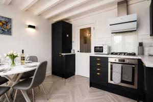 a kitchen with a table and a stove and a microwave at Beautiful Abode in The Bath Cotswolds in Frome