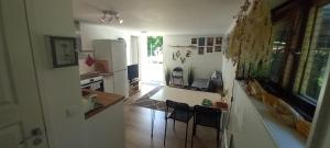 a kitchen with two chairs and a refrigerator at Stuga PETEL in Färjestaden