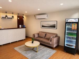 a waiting room with a couch and a drink refrigerator at CityRest Fort in Colombo