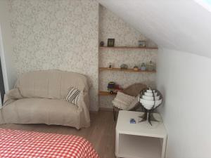 a small room with a bed and a chair at Cine in Sainte-Menehould