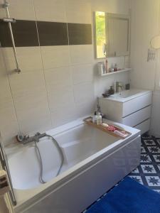 a bathroom with a tub and a sink at Cine in Sainte-Menehould