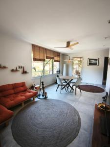 a living room with a couch and a table at Le Chant des Pierres in Saint-Pierre-des-Champs