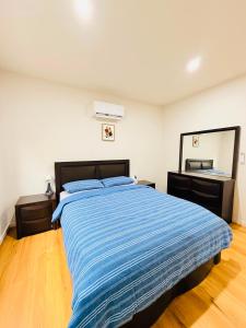 a bedroom with a bed and a large mirror at Comfort Suite with Ensuite Bathroom in Wyndham Vale