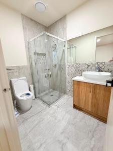 a bathroom with a shower and a toilet and a sink at Comfort Suite with Ensuite Bathroom in Wyndham Vale +13 photos