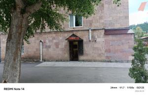 a brick building with a sign over the door at Апартаменты in Jermuk