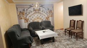 a living room with a couch and two chairs and a table at Апартаменты in Jermuk