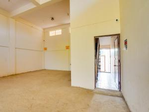 an empty room with a door leading to a hallway at Hotel O R.S in Nagpur