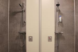 a shower stall in a bathroom with a shower at Ljusne Ice Camps in Ljusne