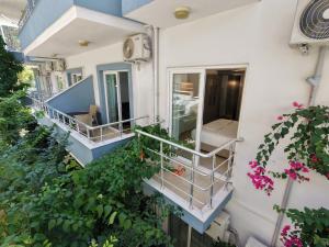 a balcony of a building with pink flowers at Kemer House Apartments in Kemer