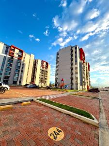 a group of buildings in a city with a street at Apartamento modero nuevo, 3 habitaciones y parqueadero en conjunto in Neiva