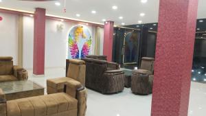 a room with a group of chairs and a colorful painting at Shravan Hotel in Rāmgarh