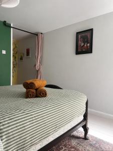 a bedroom with a bed with towels on it at Little B - Artist owned boutique apartment near Southsea beach in Portsmouth