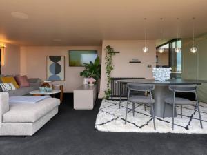 a living room with a couch and a table at Providence Cottage in Monmouth