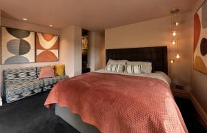 a bedroom with a large bed and a couch at Providence Cottage in Monmouth +59 photos