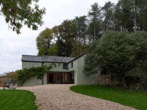a white house with a gravel driveway at Providence Cottage in Monmouth