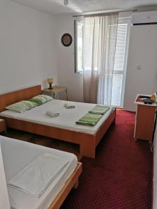 a hotel room with a bed and a window at Anika apart in Bar