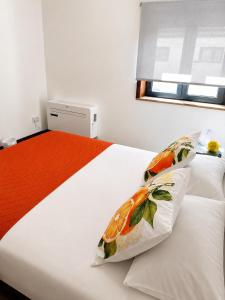 a bedroom with a bed with two pillows on it at Aveiro Ria View in Aveiro