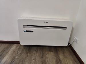 a white printer sitting on the floor next to a wall at Aveiro Ria View in Aveiro