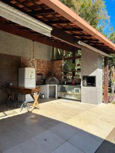 an outdoor kitchen with a table and a stove at Cantinho na Serra in Teresópolis