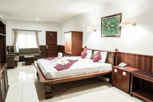 a bedroom with a bed and a living room at Melasti Kuta Beach Hotel & Spa in Kuta +60 photos