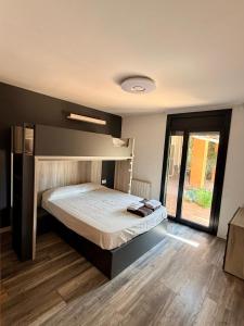 a bedroom with a bed and a large window at Cal Piano in Palol de Rebardit +23 photos