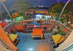 a balcony with chairs and a view of a city at Olympic Hostel in Yerevan