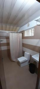 a bathroom with a toilet and a sink at Birds Murmur Camp, Thattekkad in Cochin