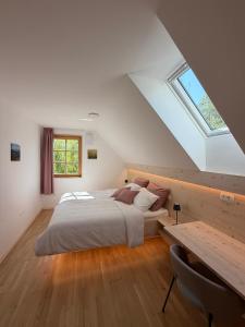 a bedroom with a bed and a desk and a window at Apartment House Belca in Preddvor