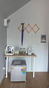 a kitchen with a table and a drying rack with an umbrella at Grace Riverfront Villa Near Suvarnabhumi Airport in Lat Krabang