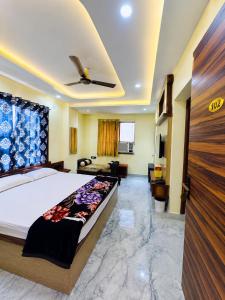 a bedroom with a bed and a living room at Hotel Shree Radhe & Banquet in Darbhanga +32 photos