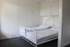 a white bed in a room with white cabinets at Ljusne Ice Camps in Ljusne