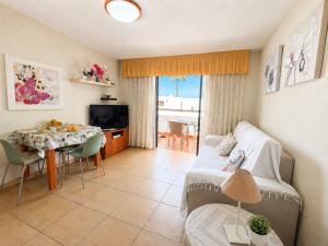 a living room with a couch and a table at Fwt Relax Bungalow in Playa de las Americas
