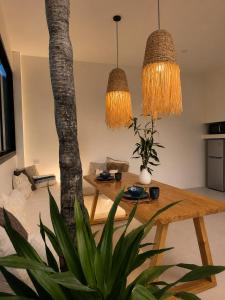 a living room with a table and a tree at La Caza Sowana in Ko Phangan