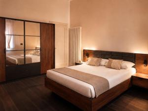 a bedroom with a large bed and a mirror at Mars41 B&B in Bologna