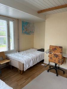 a bedroom with a bed and a desk and a chair at Country House Marja  +16 photos