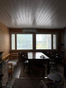 a room with a table and chairs and windows at Country House Marja 