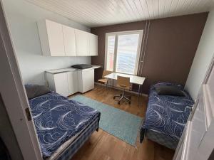 a small room with two beds and a desk at Country House Marja 