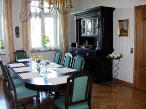 a dining room with a black table and chairs at Ferienzimmer Günther Objekt 28985 in Rostock