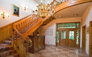 a staircase in a home with a chandelier at Ferienzimmer Günther Objekt 28985 in Rostock