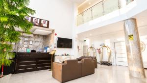 a living room with a couch and a piano at توارن للشقق المخدومة - اقتصادي in Hail +35 photos