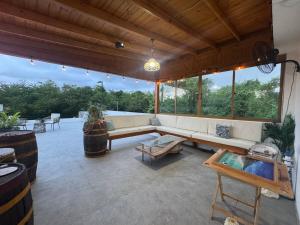a large patio with a couch and a table at Villa danexia in Juan Dolio