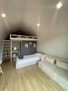 a room with two beds and a desk in it at Grace Riverfront Villa Near Suvarnabhumi Airport in Lat Krabang
