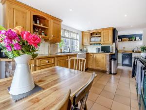 a kitchen with a table with a vase of flowers on it at Pen Y Groes in Welshpool