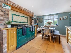 a kitchen with a green stove and a dining room at Pen Y Groes in Welshpool +22 photos