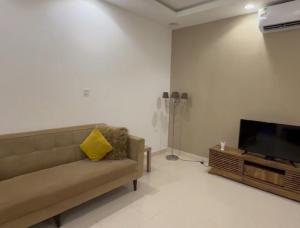 a living room with a couch and a flat screen tv at الوجه مخطط 110 in Al Wajh