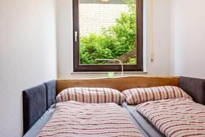 a bed in a room with a window at Ferienwohnung Schnucki Lautenthal in Lautenthal