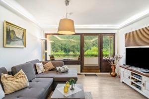a living room with a couch and a tv at Ferienwohnung Schnucki Lautenthal in Lautenthal
