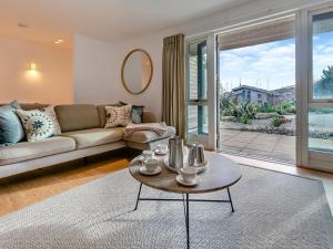a living room with a couch and a table at Lodge 53 Una in Carbis Bay