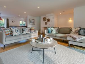 a living room with two couches and a coffee table at Lodge 53 Una in Carbis Bay